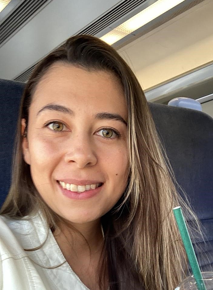 Jenna Bishop seated on a train